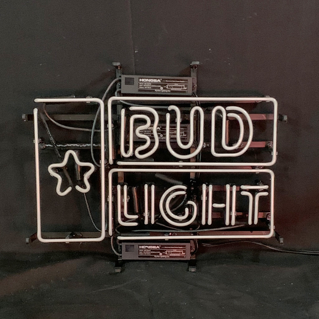 White neon light sign with a star and a stylized can design next to the words 'BUD LIGHT' in uppercase letters on a black background.