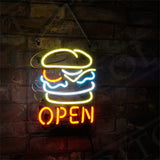 Neon sign featuring a yellow burger outline with red, white, and blue details above the word OPEN in bright red, mounted on a dark brick wall and hanging by a chain.