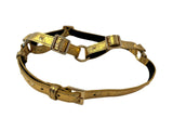 Gold embossed Italian leather harness with multiple adjustable buckles and a central metal ring, designed with studded detailing and dark edging.