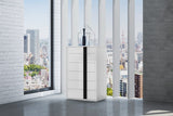 White chest of drawers with a central vertical black stripe, positioned in a modern room with large windows overlooking a cityscape.