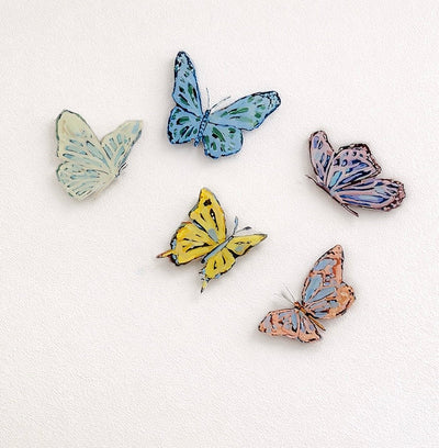 Yellow "Butterfly Wishes" acrylic wall contour artwork mounted on a white wall