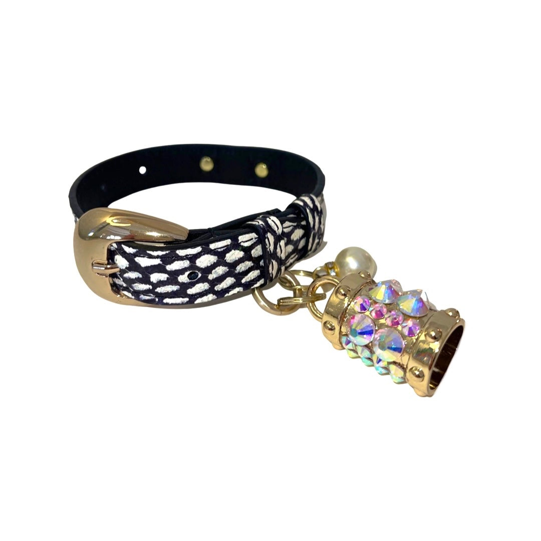 White and navy polka dot dog collar with gold hardware and Swarovski crystal charm and pearl displayed on neutral background