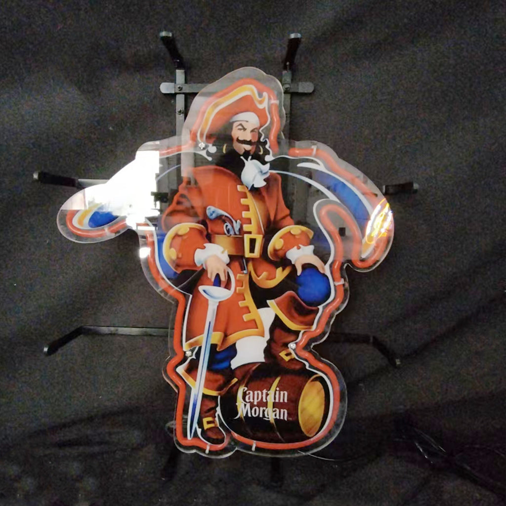Neon sign featuring the Captain Morgan pirate in red coat holding a sword and standing with one foot on a barrel labeled 'Captain Morgan', with illuminated blue and orange accents.