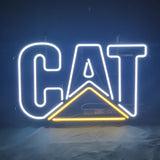Caterpilla Cat Neon Sign glowing pink on metal grid backing