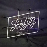 White neon light sign spelling 'Schlitz' in cursive within a tilted rectangular frame against a dark background with support brackets.