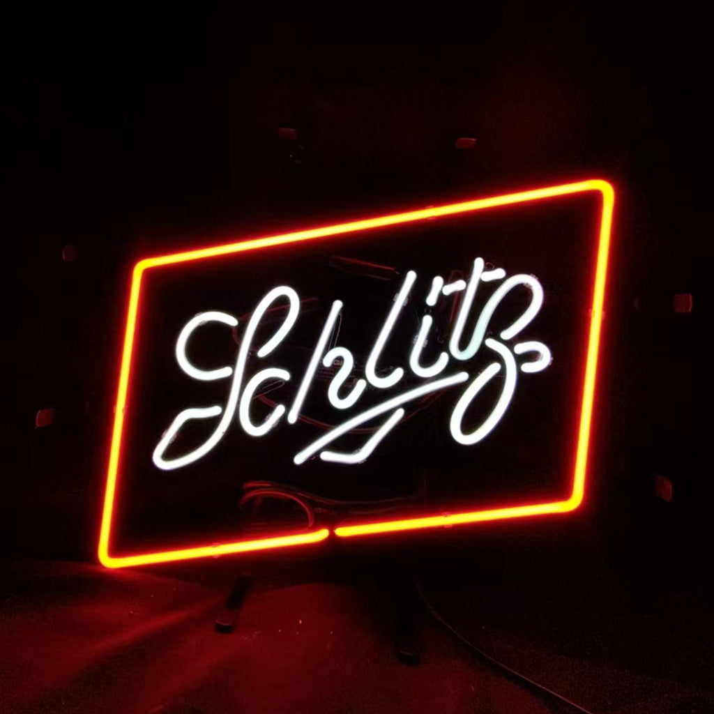 Rectangular neon sign with bright red-orange border and white cursive text spelling 'Schlitz' on a black background.