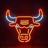Neon sign featuring an orange outline of a bull's head with white and orange horns against a dark background