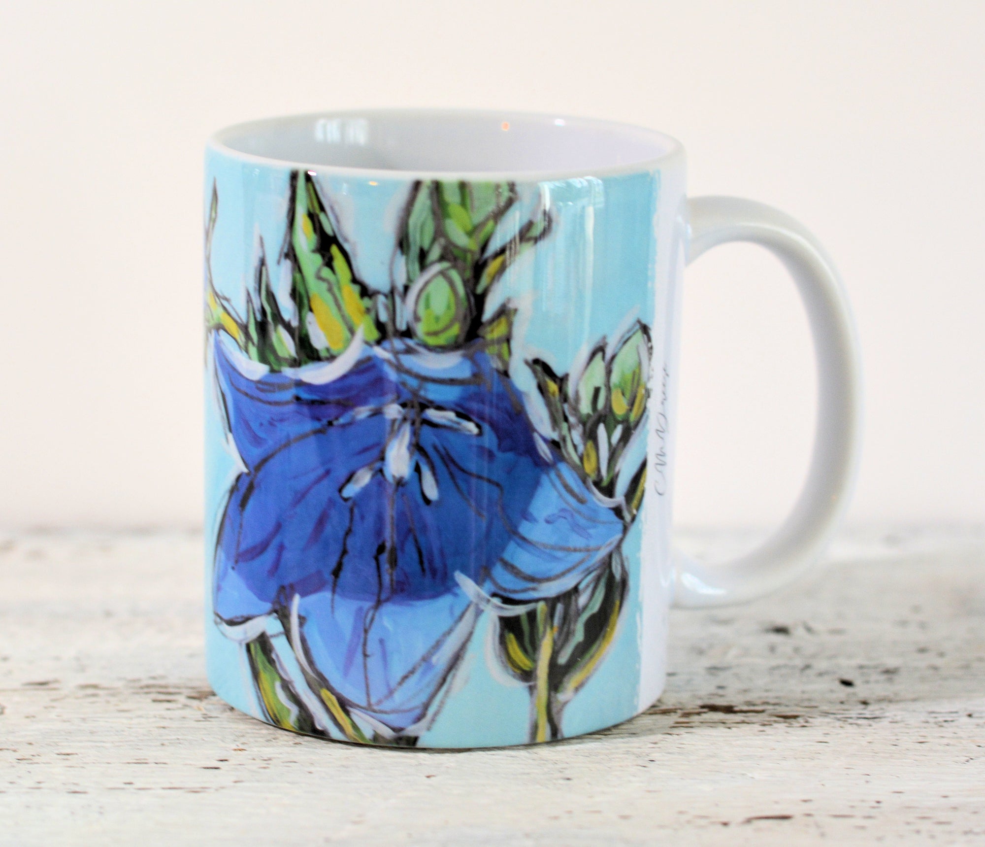 Blue Bell Flower ceramic mug holding artful floral design by Christi Dreese