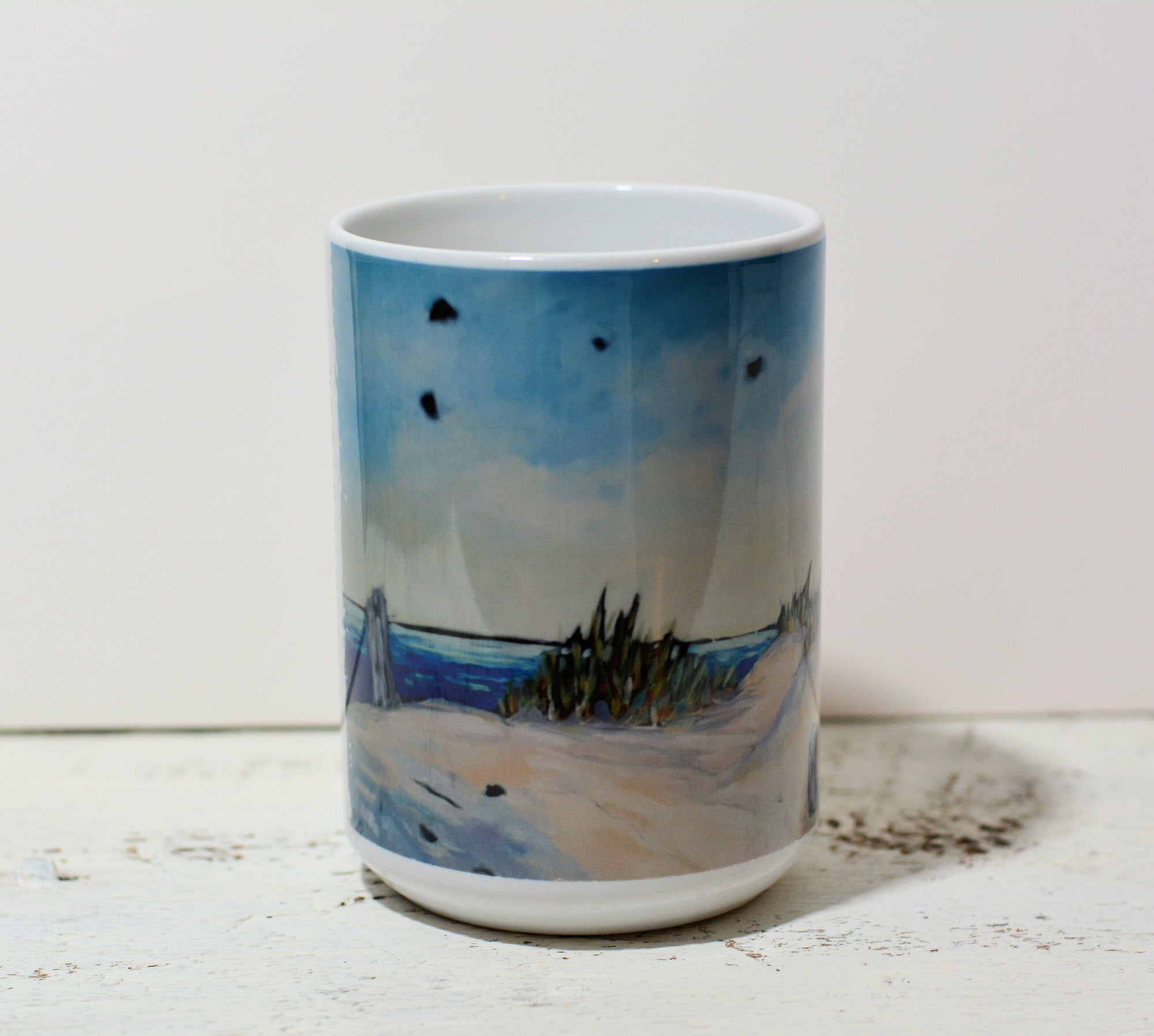 Ceramic mug from Dreese Fine Art featuring Lake Michigan Beach original artwork with blue and sand tones