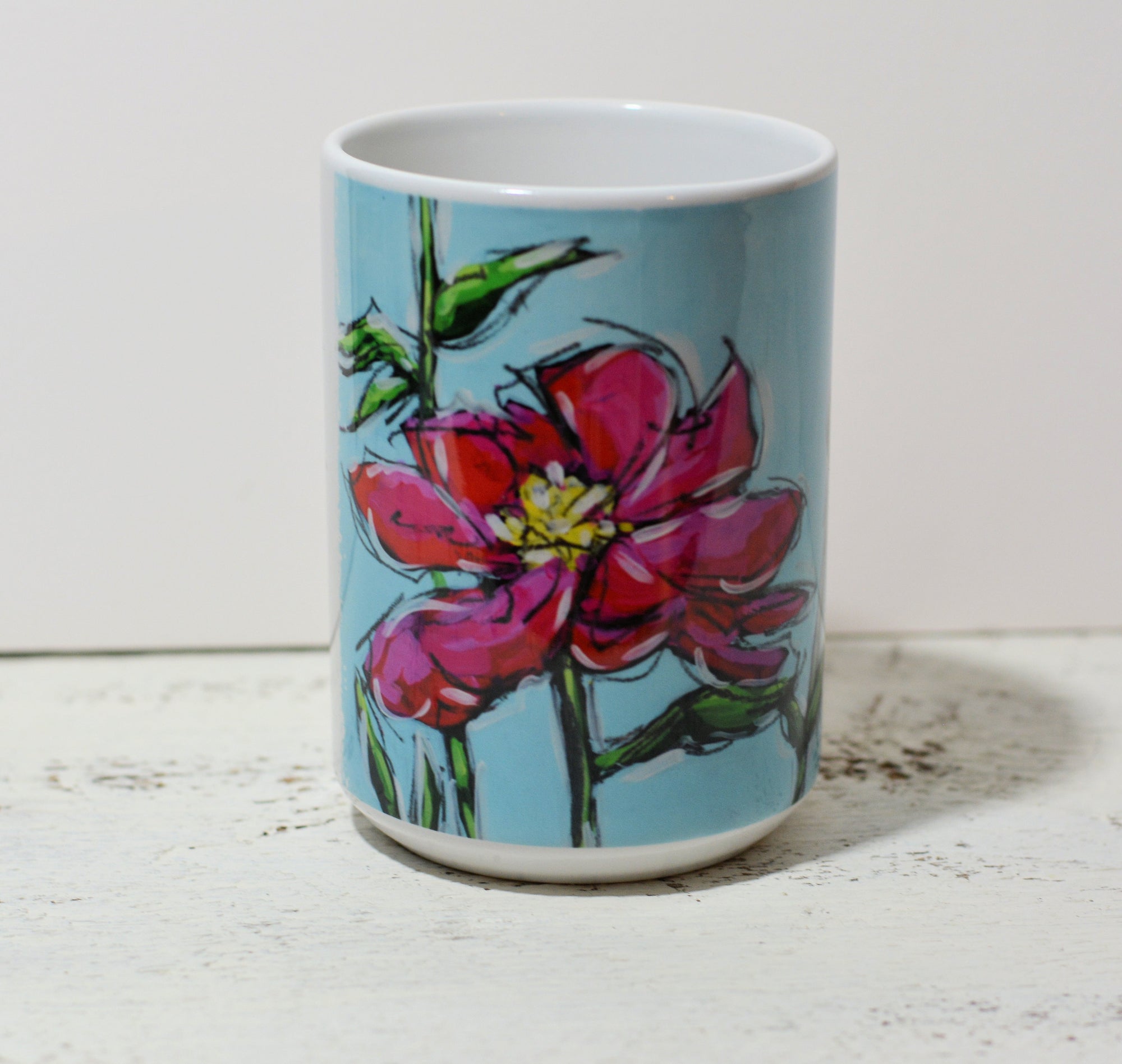 Ceramic mug featuring the Pink Peony artwork by Christi Dreese displayed on a table