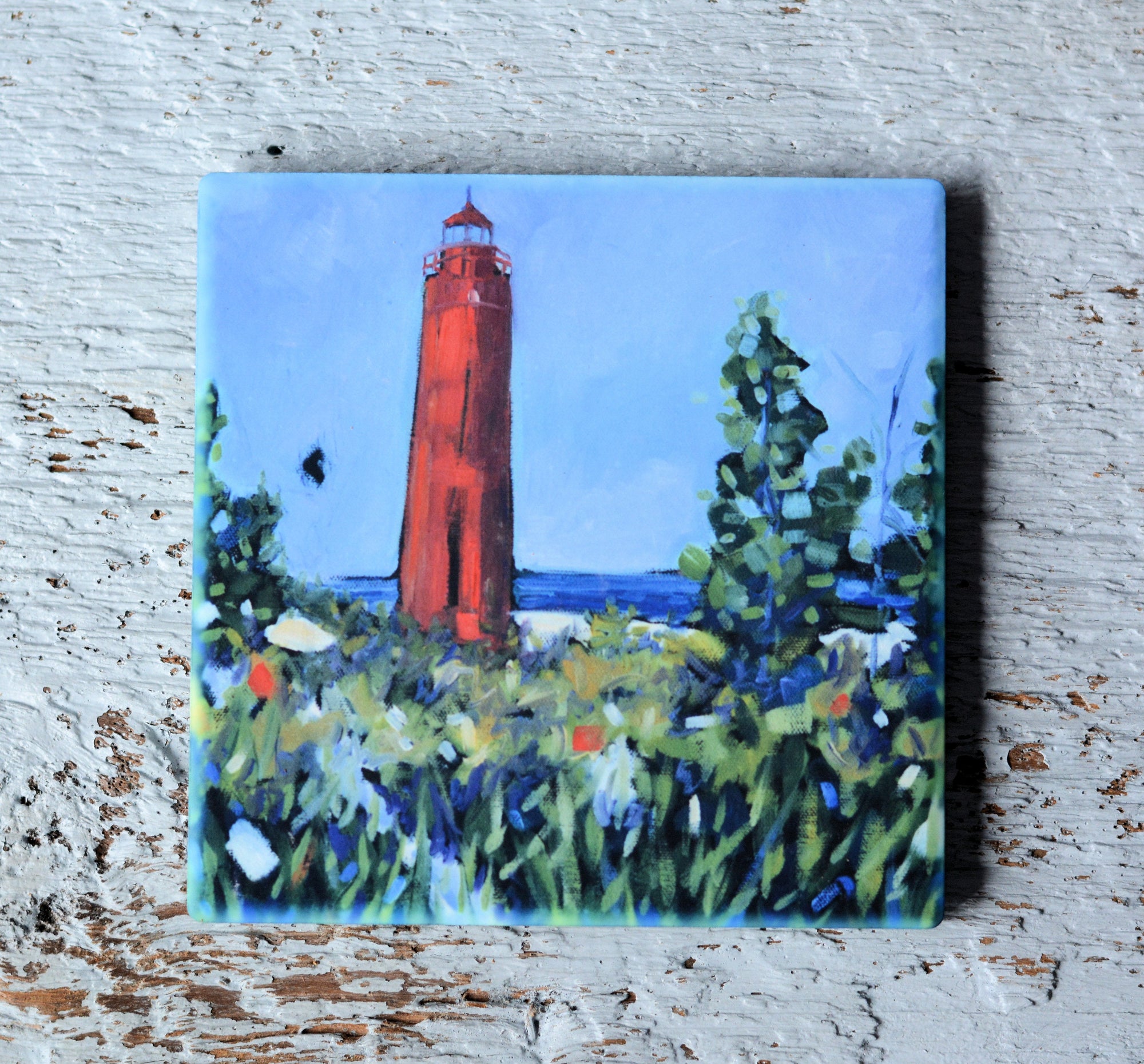 Coasters and magnet featuring Ludington Lighthouse artwork by Christi Dreese