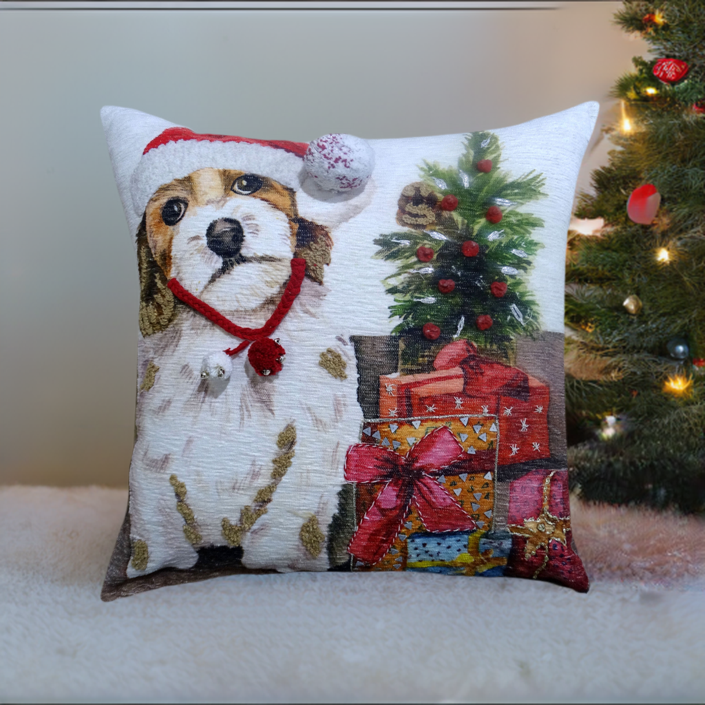 Square pillow featuring a dog wearing a red and white Santa hat beside a decorated miniature Christmas tree and colorful wrapped gifts on a cozy surface