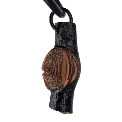Cladira pendant necklace displayed on natural surface, showing organic texture and unique shape