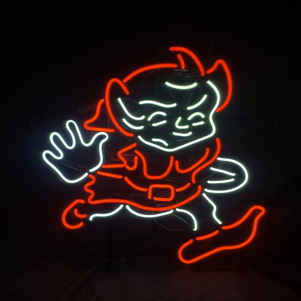 Neon sign featuring a stylized cartoon figure outlined in bright red and white lights, depicting a running person with an expressive face and a raised hand.