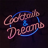 Pink neon cursive text 'Cocktails & Dreams' encircled partially by a blue neon oval on a dark background.