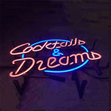Neon sign with pink cursive text reading 'Cocktails & Dreams' encircled by a glowing blue oval on a dark background.