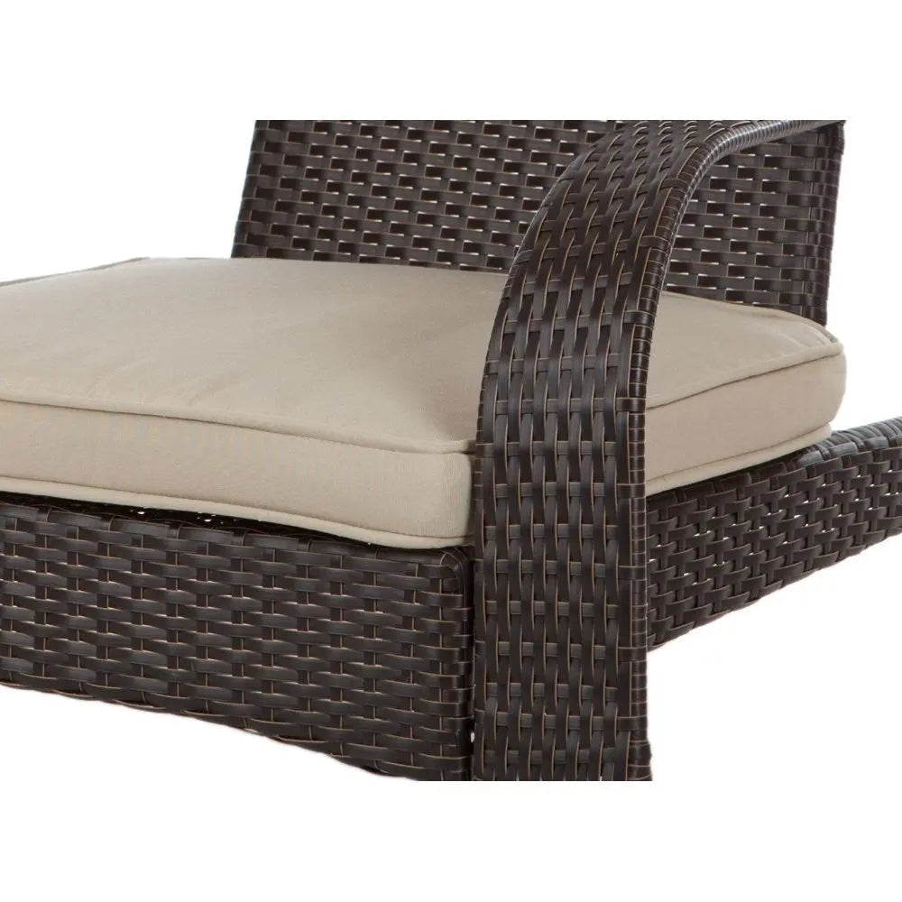 Close-up of dark brown woven wicker armrest and beige cushion on a chair with textured wicker pattern and smooth cushion edges.