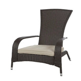 Dark brown woven wicker armchair with tall curved back and beige seat cushion, featuring angled legs with silver caps, shown isolated on white.