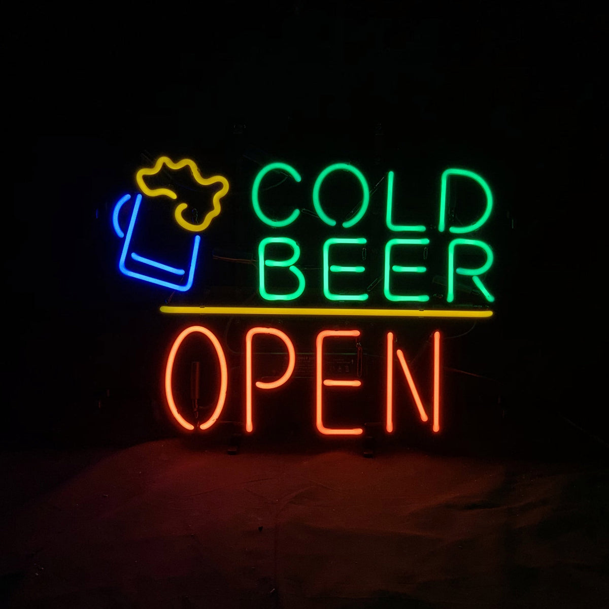 Neon sign with a blue beer mug and yellow foam icon, green letters spelling 'COLD BEER' above a horizontal yellow line, and red letters spelling 'OPEN' below.