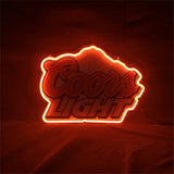 Coors Light logo outlined with bright red neon light glowing against a dark background highlighting bold cursive and block lettering.