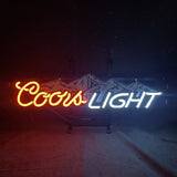 Neon sign with a red script 'Coors' and white block 'LIGHT' letters, featuring blue and white mountain peaks behind the text on a dark background.