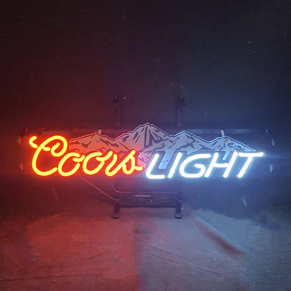 Coors Light with Snow Mountain Neon Sign lit up against a dark backdrop