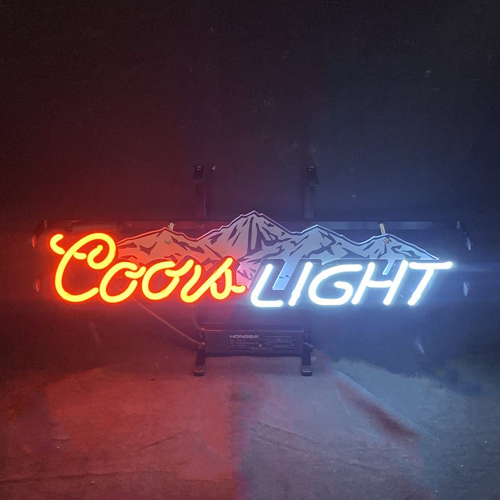 Coors Light with Snow Mountain Neon Sign lit up against a dark backdrop