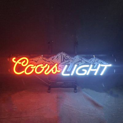 Coors Light with Snow Mountain Neon Sign lit up against a dark backdrop