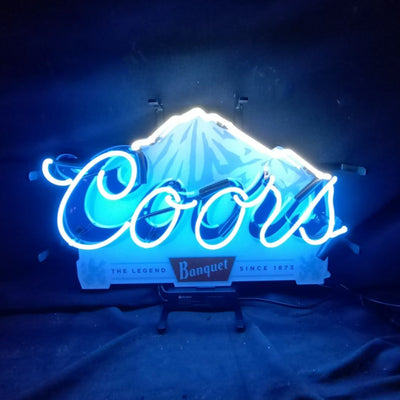 Coors The Legend Banquet Since 1873 neon sign glowing indoors with warm yellow and white neon on acrylic backing