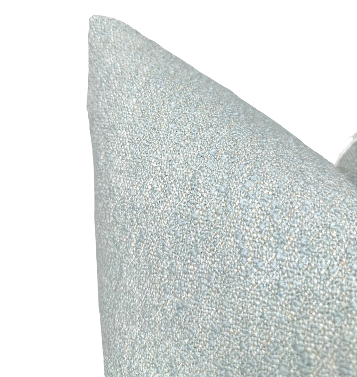 Close-up of a light blue boucle pillow cover with a textured, looped fabric surface, shown against a white background.