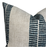 Close-up of a pillow cover featuring wide natural beige fabric panels and narrow indigo blue bands with small white dot patterns along the edges