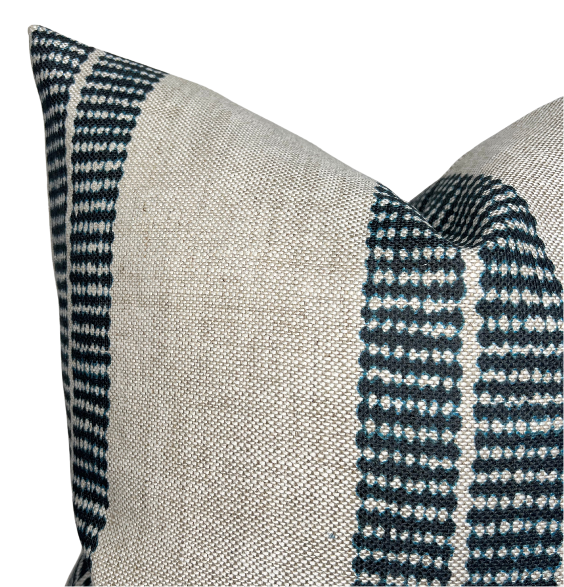 Close-up of a pillow cover featuring wide natural beige fabric panels and narrow indigo blue bands with small white dot patterns along the edges