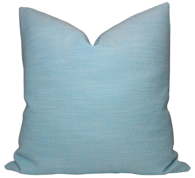 Outdoor Rough 'n Rowdy Woven Pillow Cover in Poolside Blue on light-colored seating