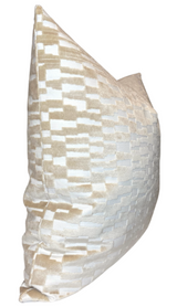 Square pillow cover with a tan and white geometric textured velvet pattern, shown from a side angle highlighting its plump shape and soft fabric.