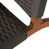 Close-up of dark gray woven rope seat and backrest attached to wooden chair frame with brass corner bracket and screws on white background