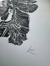 Black and white woodcut print of a crab apple tree ring with detailed grain patterns and an artist's signature in the lower right corner on white paper.