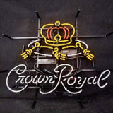 Neon light sign featuring a yellow and orange crown above white cursive lettering reading 'Crown Royal' on a black backing with visible power components.