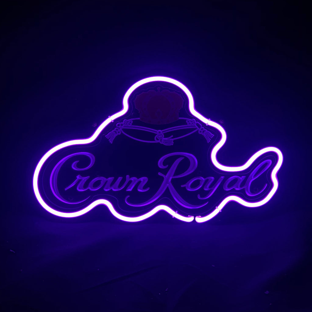 Purple neon light outlining the Crown Royal logo and text on a dark background, with glowing accents highlighting the signature crown shape.