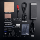 Arrangement of Cubiko CNC Router accessories including wood chips, PCB copper clad laminates, alligator clamp, USB cable, power supply, wrenches, aluminum clamps, drill bits, collet, SD card, card reader, cable ties, and EVA feet.