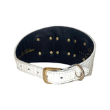 White textured 4-inch wide leather collar with gold buckle and multiple small gold rivets on the inner black lining, shown in a curved position.