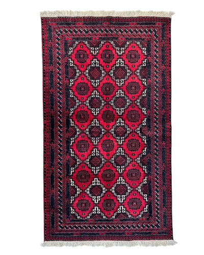 Hand-knotted Afghani Baluch wool rug showing geometric pattern in earth tones