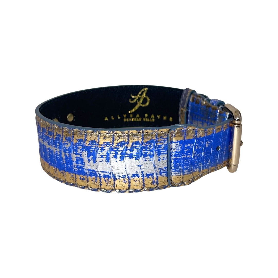 Classic dog collar with a textured pattern featuring blue, silver, and gold colors and gold hardware buckle, shown against a white background.