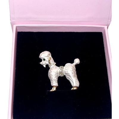 Pearl White Poodle Brooch by Allysa Payne Beverly Hills displayed on brown fabric