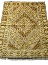 Hand-knotted Afghani Nakhunak wool rug with a central diamond pattern and geometric borders in shades of gold, brown, and cream, measuring approximately 4 by 5 feet.