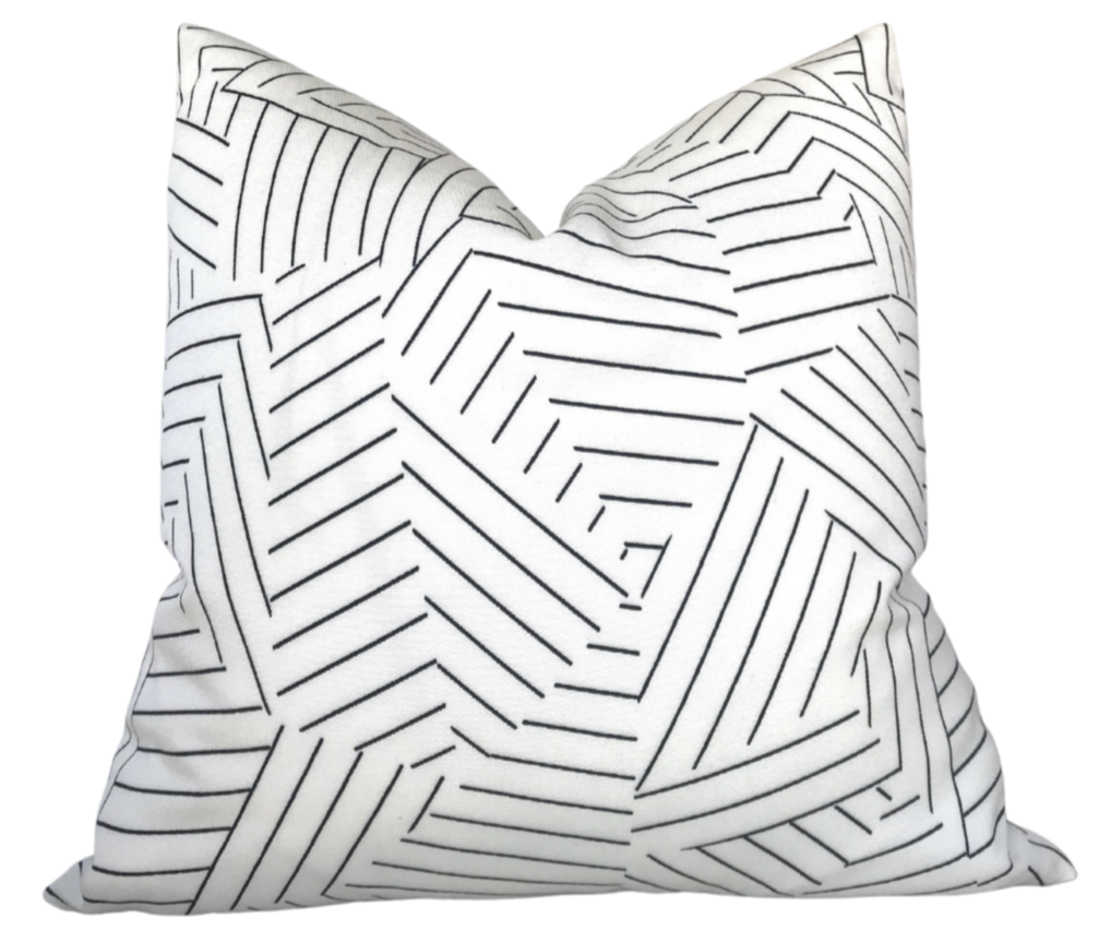 Black and ivory deconstructed stripe pillow cover from DEKOWE shown indoors