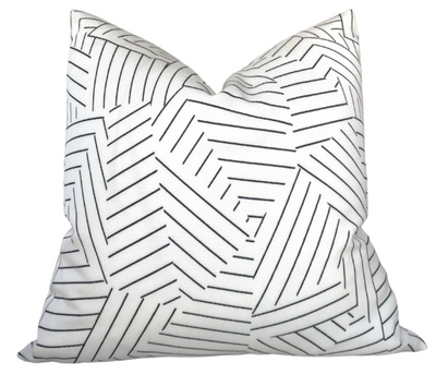 Black and ivory deconstructed stripe pillow cover from DEKOWE shown indoors