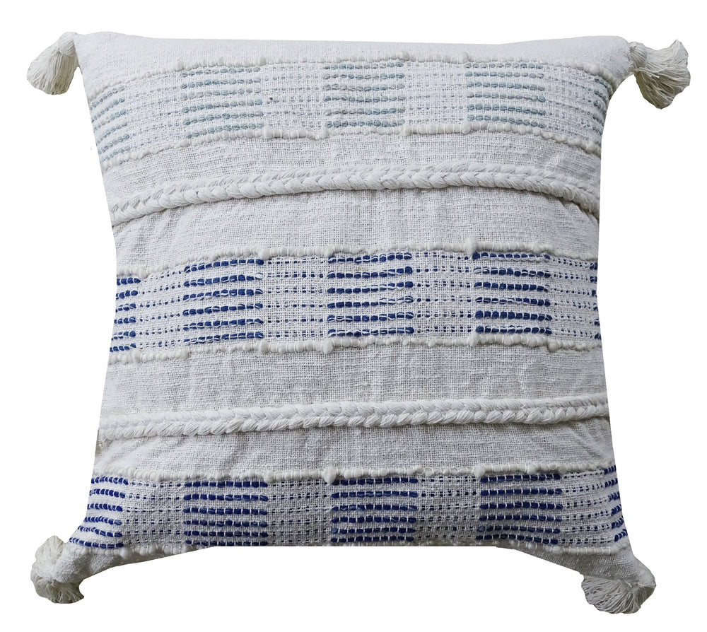 Blue and white square throw pillow with tassels on a sofa