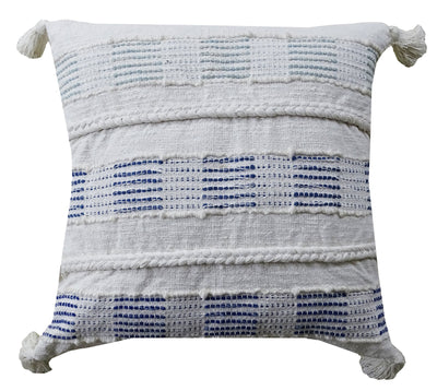Blue and white square throw pillow with tassels on a sofa