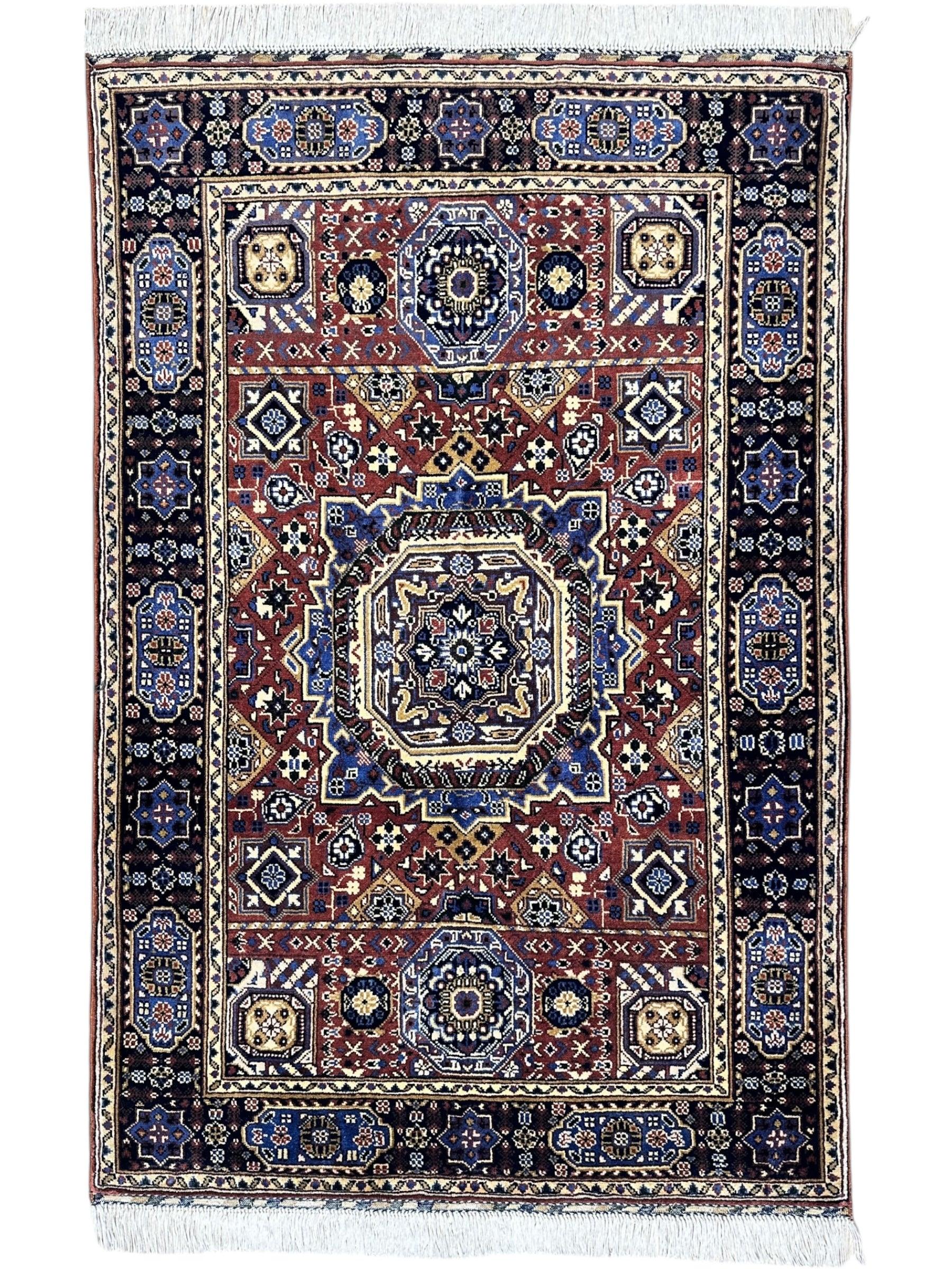 Hand-knotted Afghani Mamluk rug in blue and brown with geometric motifs, displayed on wooden floor