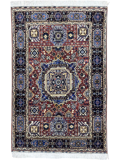 Hand-knotted Afghani Mamluk rug in blue and brown with geometric motifs, displayed on wooden floor